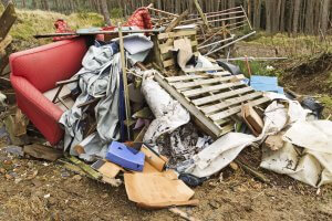 Fly tipping waste in woodlands